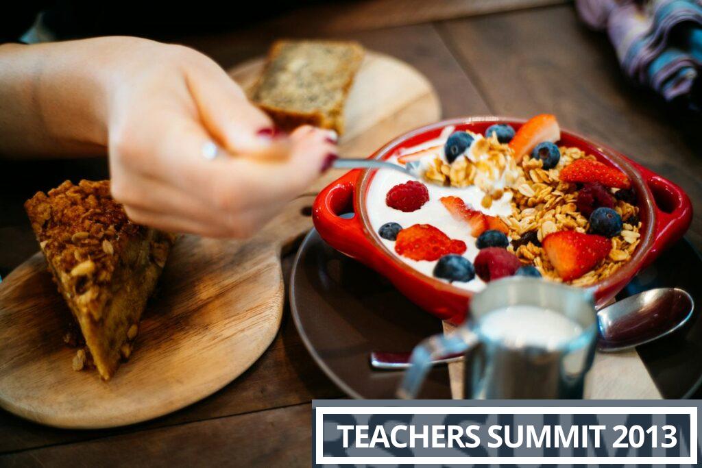 Close-up of a breakfast setting with granola, fresh berries, and a slice of cake.