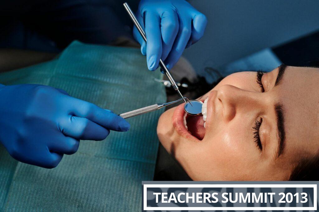 Close-up of a dentist examining a patient's teeth using dental tools.